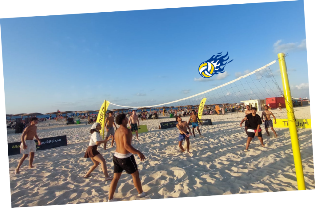 Players in action at a beach volleyball match on the North Coast
